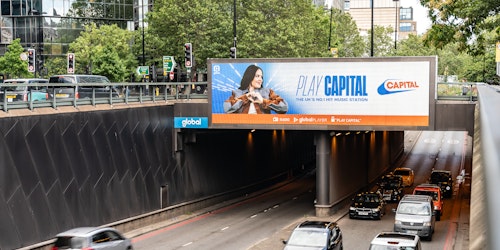 A billboard over a busy road