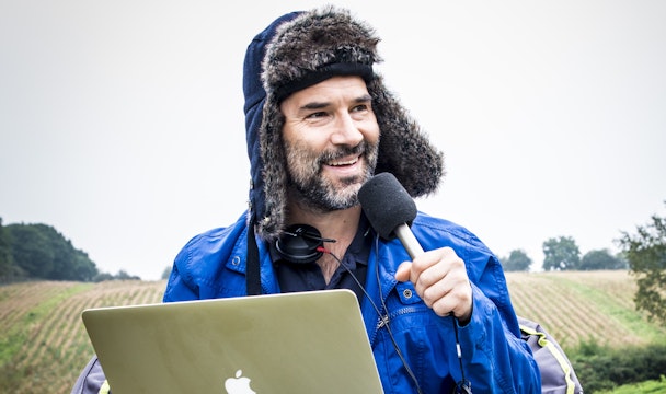 Adam Buxton recording a podcast in a field