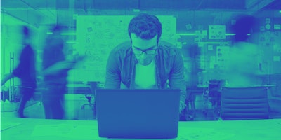 Man sat in front of computer in office 