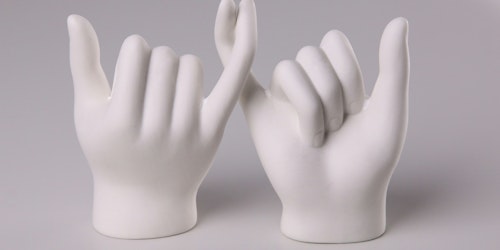 Two white models of hands link little fingers in a gesture that symbolizes a promise being made