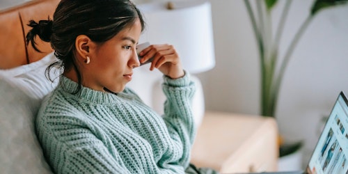 A woman looks at an e-commerce site on her laptop