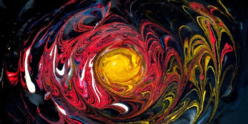 A swirl of oil-based paint, resembling the star at the center of a galaxy