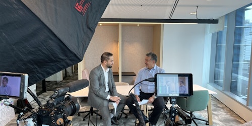 Two men sit down for a filmed interview