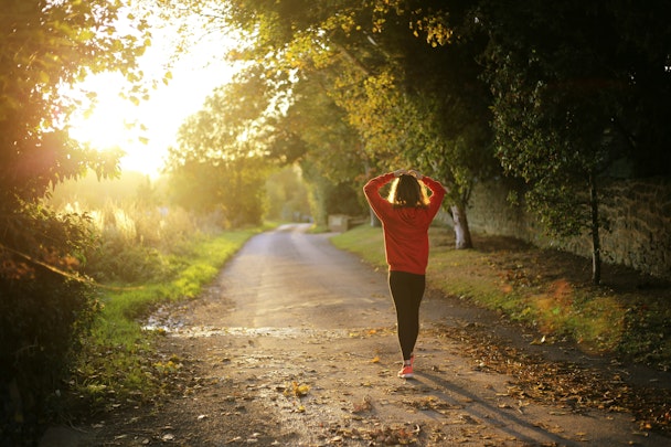 Woman walking on sunny path