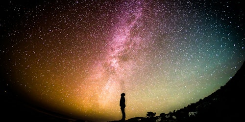 A person standing in front of a field of stars