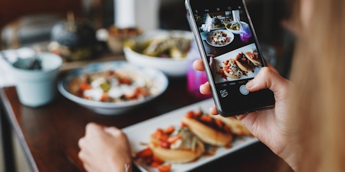 Someone taking a picture of food