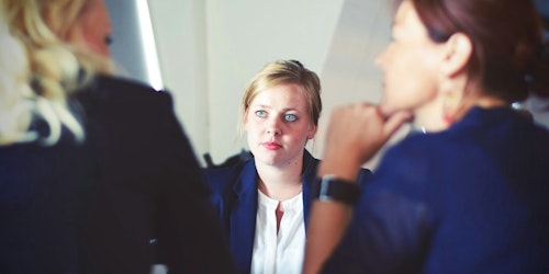 A woman being interviewed by two other women