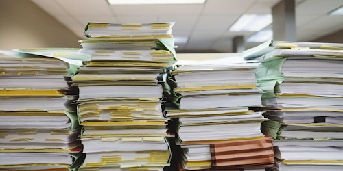 Piles of paper on a desk