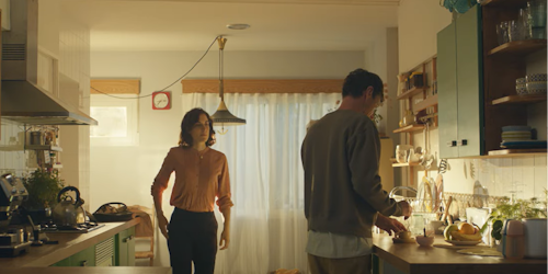 Husband and wife in the kitchen making coffee