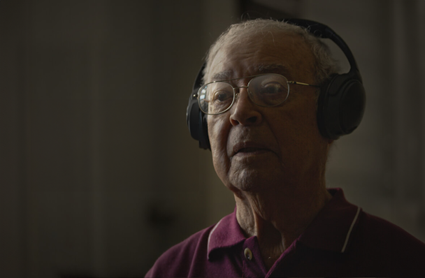 an older man listening to music on headphones