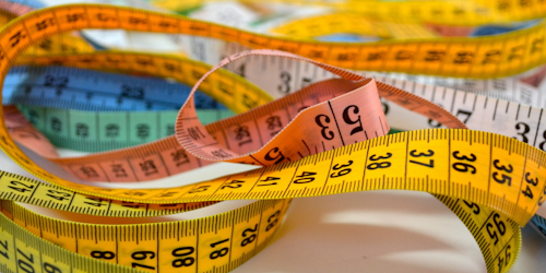 Colorful measuring tapes in a heap