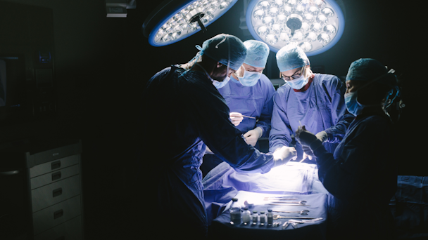 Surgeons looming over a patient